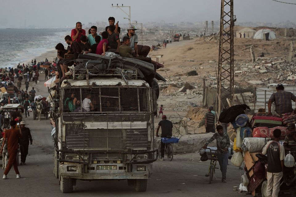 Displaced Palestinians flee Gaza City carrying their belongings along the coastal road towards southern Gaza.  Photo: AP